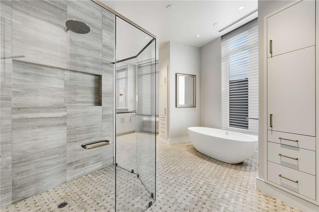 3376 Peachtree Road Northeast, Unit 33B Atlanta, GA 30326 - Photo 22 of 45 a bathroom with a granite countertop sink a toilet and shower