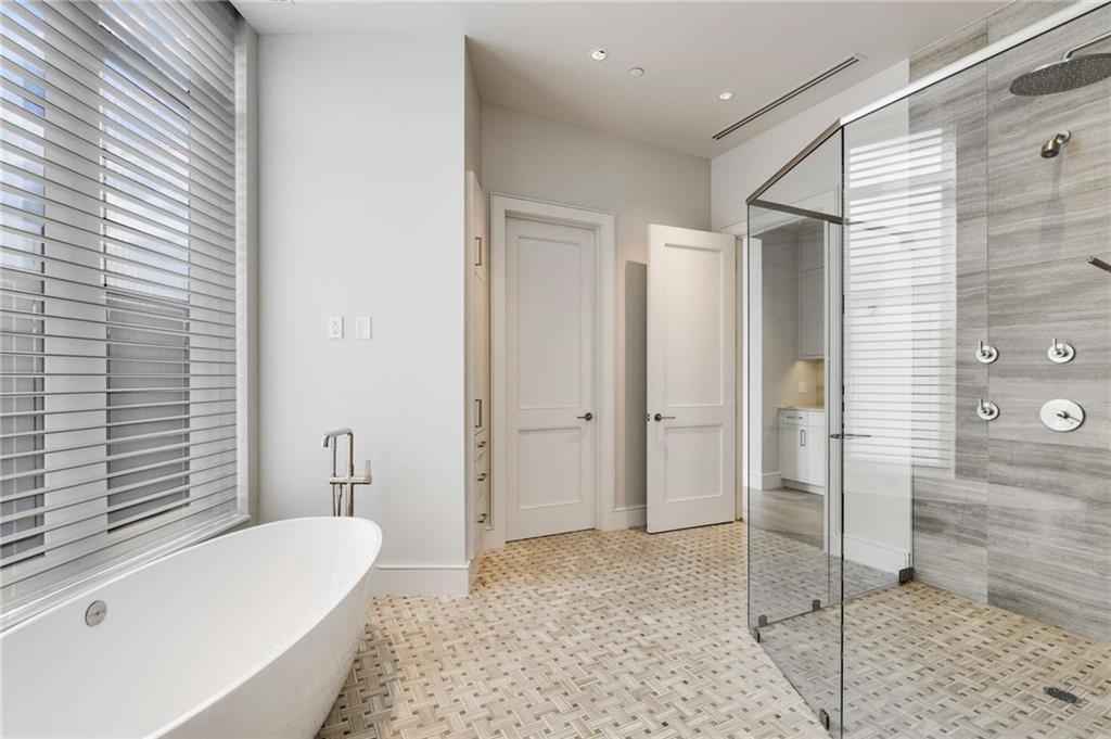 3376 Peachtree Road Northeast, Unit 33B Atlanta, GA 30326 - Photo 23 of 45 a bathroom with a tub shower and sink