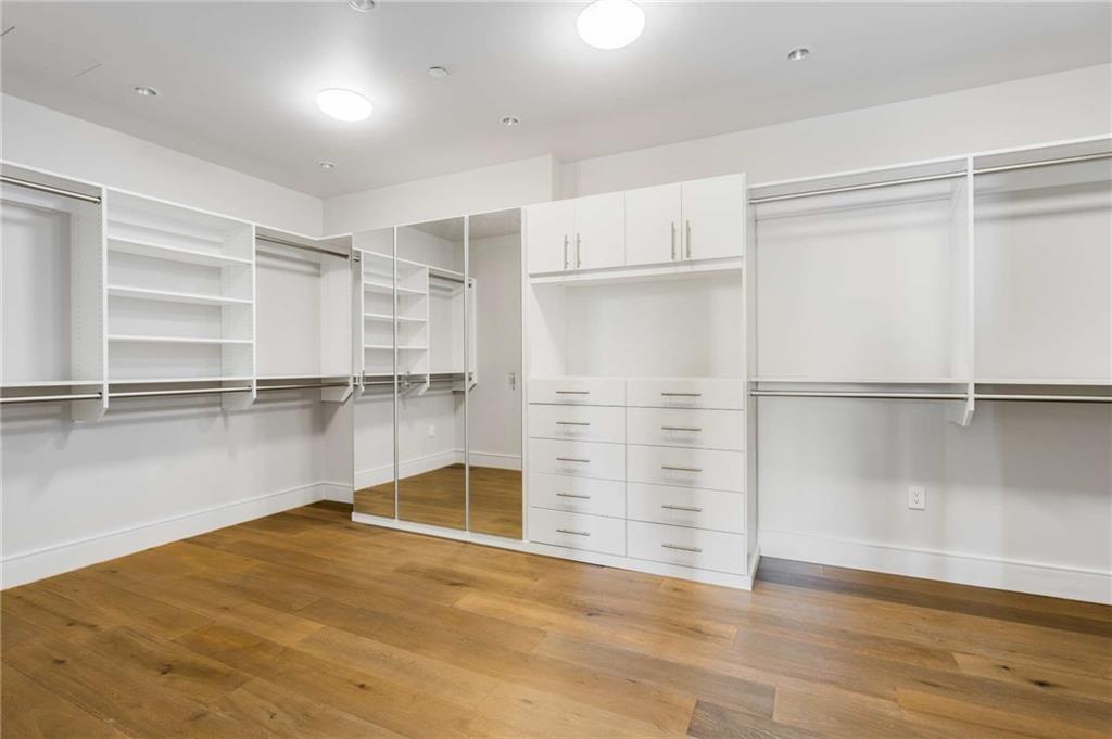 3376 Peachtree Road Northeast, Unit 33B Atlanta, GA 30326 - Photo 25 of 45 a view of empty room with wooden floor and cabinet