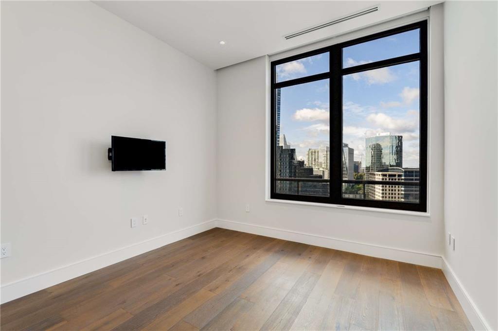 3376 Peachtree Road Northeast, Unit 33B Atlanta, GA 30326 - Photo 28 of 45 a view of a room with wooden floor and window