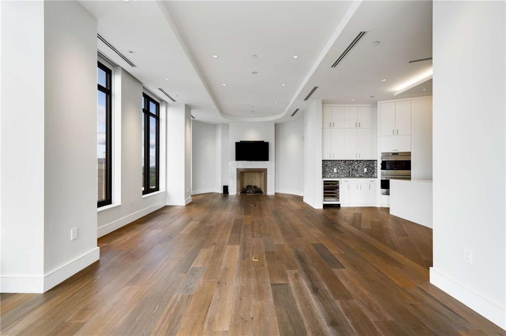 3376 Peachtree Road Northeast, Unit 33B Atlanta, GA 30326 - Photo 3 of 45 a view of kitchen with microwave a stove and wooden floor