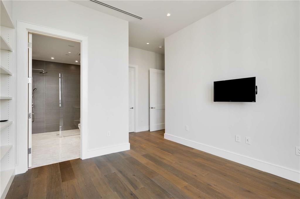 3376 Peachtree Road Northeast, Unit 33B Atlanta, GA 30326 - Photo 32 of 45 a view of a livingroom with wooden floor and flat screen tv