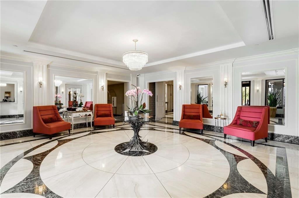 3376 Peachtree Road Northeast, Unit 33B Atlanta, GA 30326 - Photo 40 of 45 a living room with furniture and a dining table with wooden floor