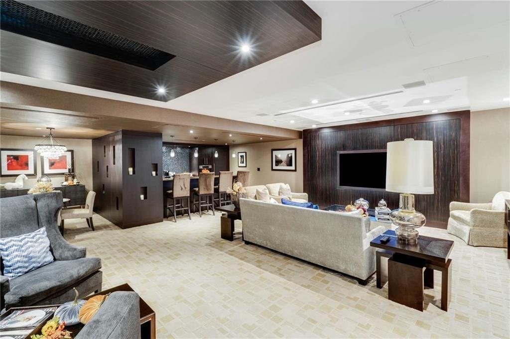 3376 Peachtree Road Northeast, Unit 33B Atlanta, GA 30326 - Photo 41 of 45 a living room with furniture and a flat screen tv