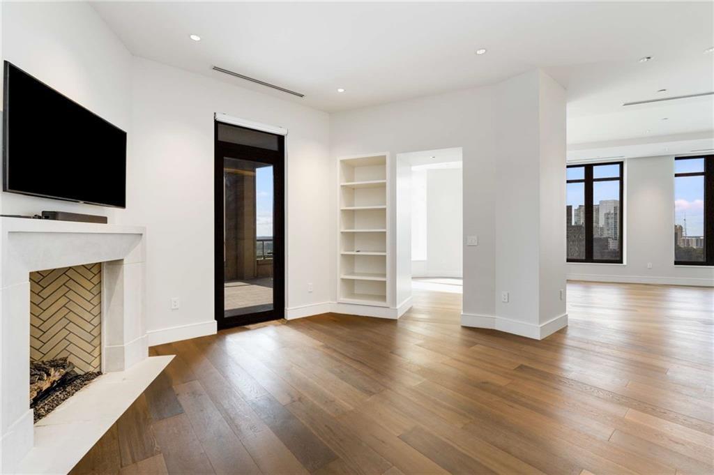 3376 Peachtree Road Northeast, Unit 33B Atlanta, GA 30326 - Photo 7 of 45 a view of a livingroom with wooden floor and a fireplace