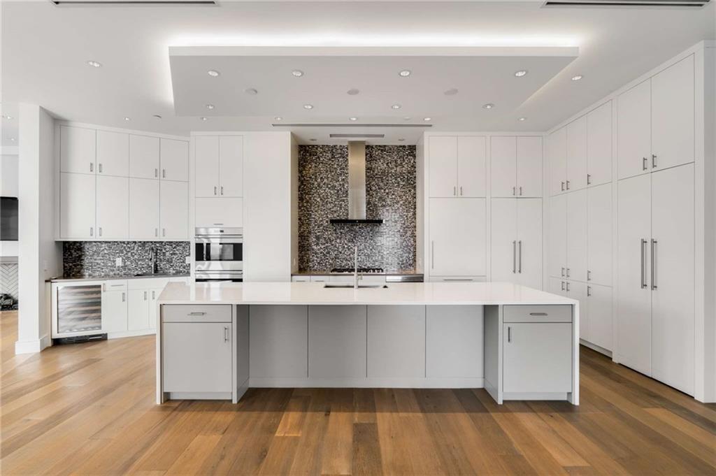 3376 Peachtree Road Northeast, Unit 33B Atlanta, GA 30326 - Photo 10 of 45 a kitchen with stainless steel appliances a sink and cabinets