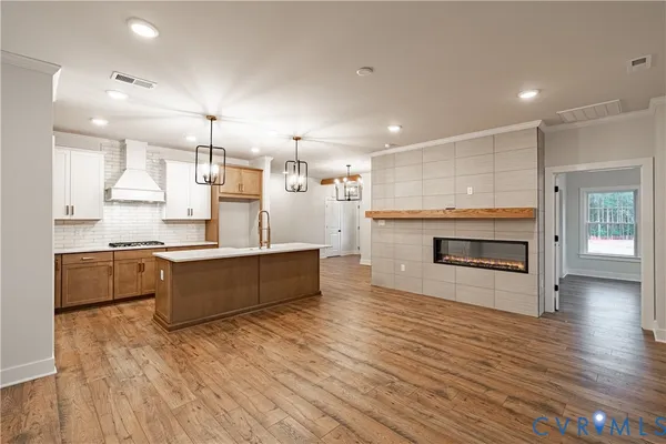 a large kitchen with a wooden floor and a kitchen island