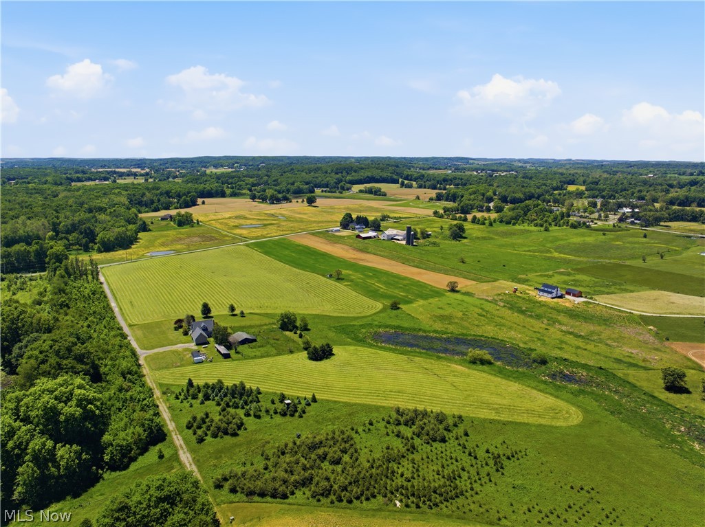 12159 Lawndell Road Southwest Beach City, OH 44608 - Photo 47 of 49 Expansive agricultural landscape featuring multiple fields, wooded areas, and a visible pond