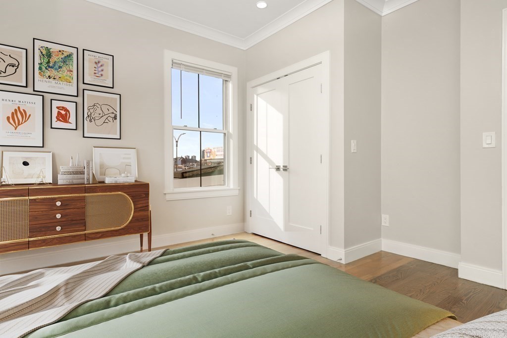 134 Chelsea Street, Unit 1 Boston, MA 02128 - Photo 3 of 13 a bedroom with a bed and a window