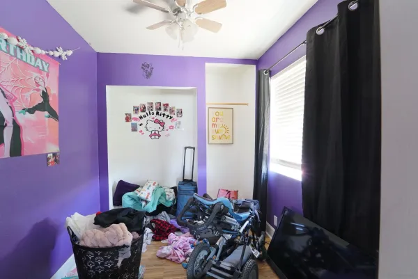 a bedroom with furniture and a flat screen tv