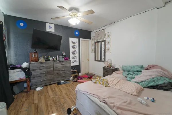a bed sitting in a bedroom next to a window