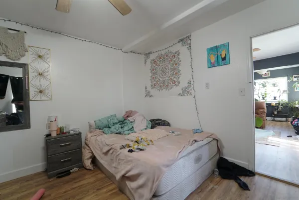 a bedroom with a bed and a window