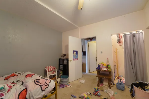 a bedroom with a bed and a chandelier