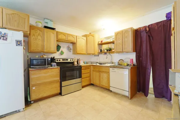 a kitchen with a sink stove and refrigerator