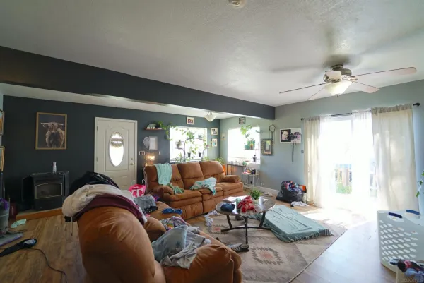 a living room with furniture a rug and wooden floor