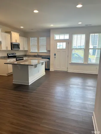 a large kitchen with stainless steel appliances granite countertop a large counter top and a stove