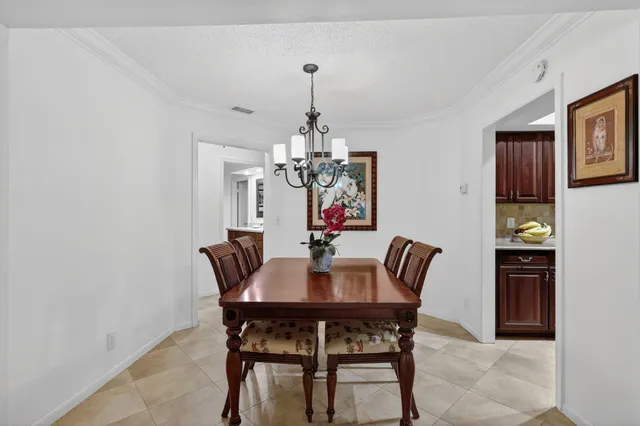 a view of a dining room with furniture and chandelier