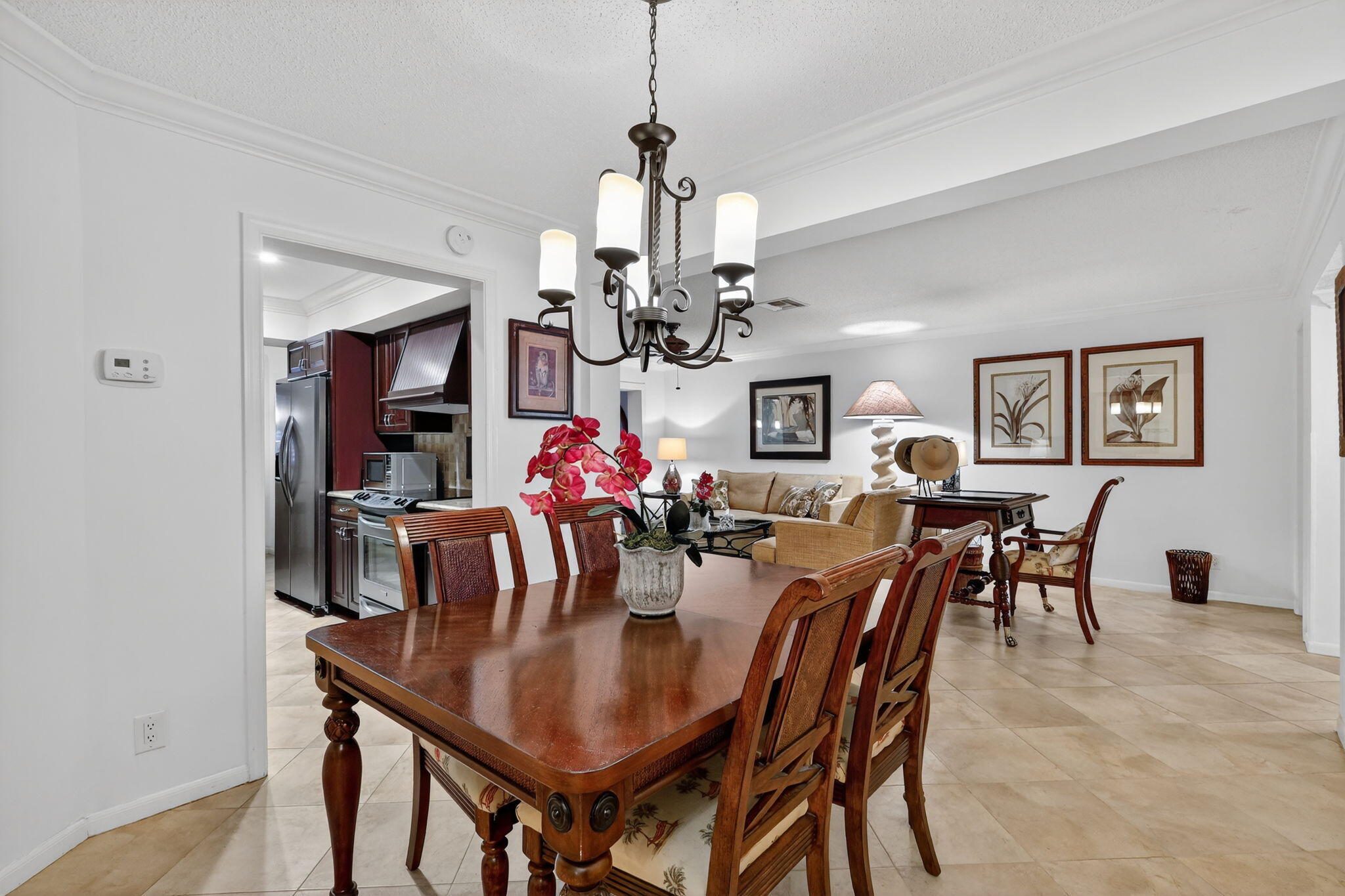 318 Southeast 7th Avenue, Unit 3 Delray Beach, FL 33483 - Photo 16 of 26 a view of a dining room with furniture and chandelier