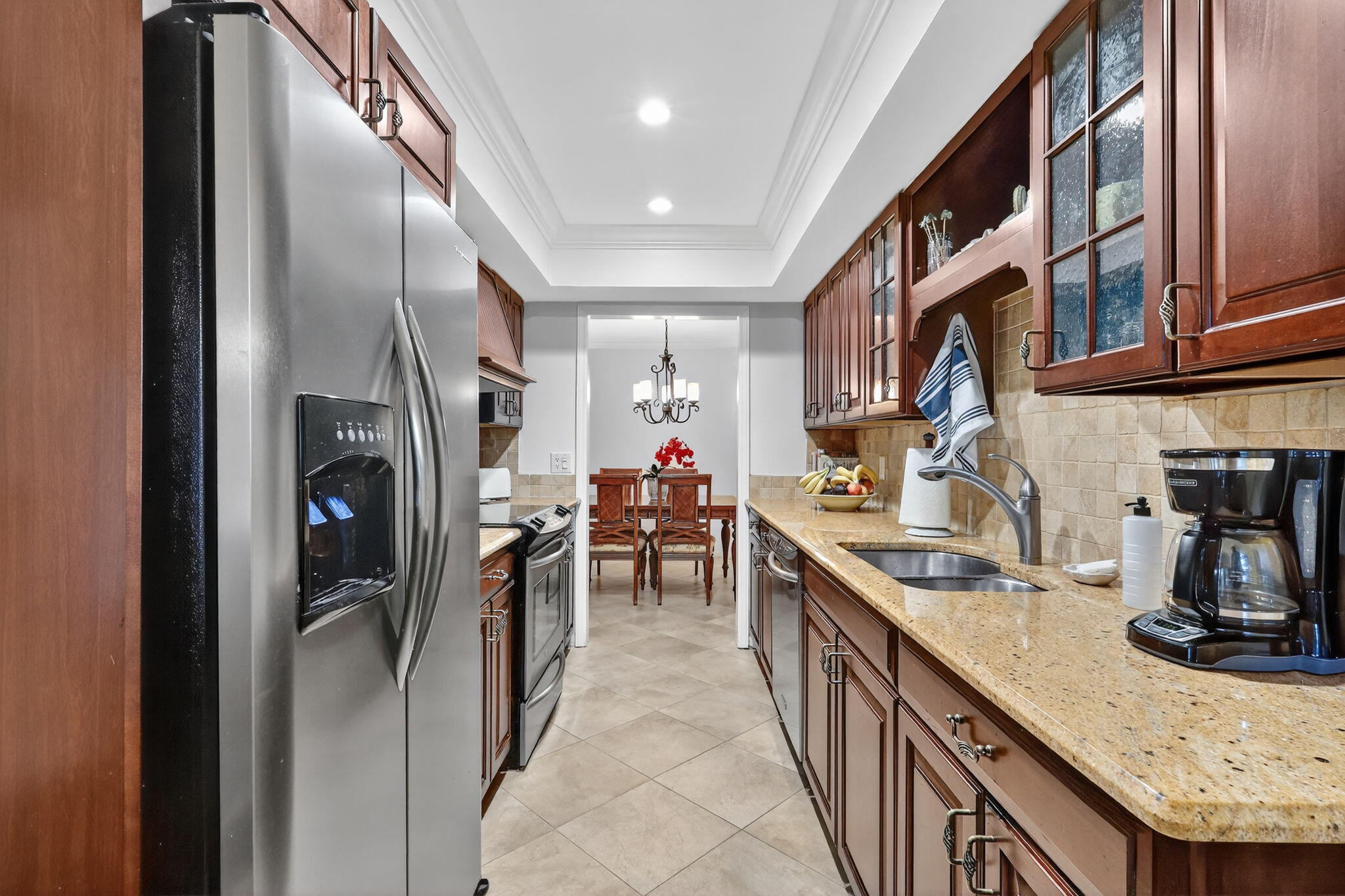 318 Southeast 7th Avenue, Unit 3 Delray Beach, FL 33483 - Photo 18 of 26 a kitchen with stainless steel appliances granite countertop a sink and cabinets