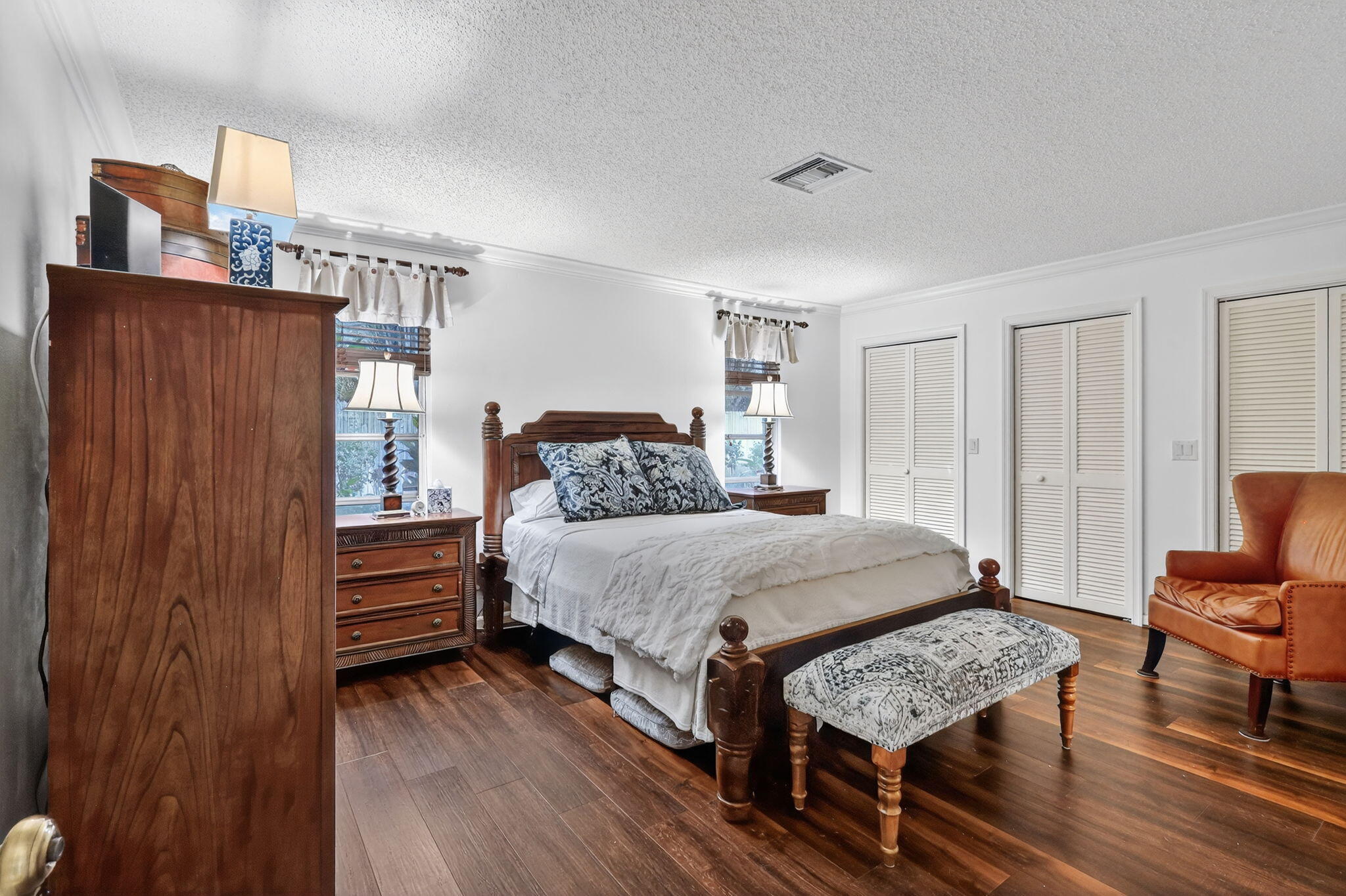 318 Southeast 7th Avenue, Unit 3 Delray Beach, FL 33483 - Photo 20 of 26 a bedroom with a bed and wooden floor