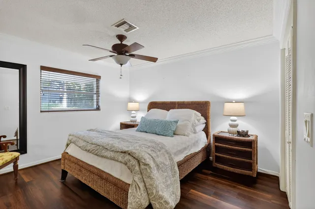 a bedroom with bed and a chandelier