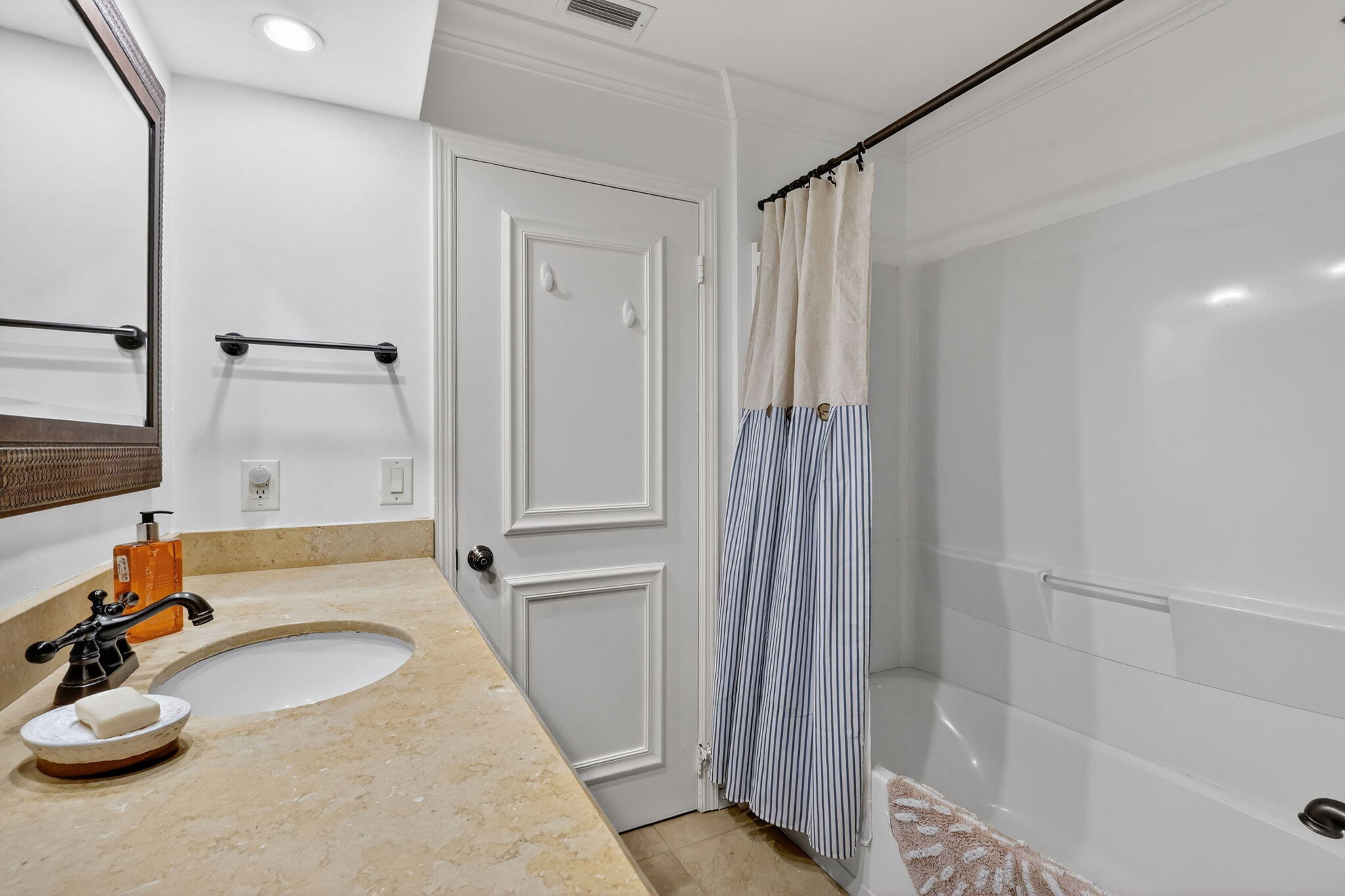 318 Southeast 7th Avenue, Unit 3 Delray Beach, FL 33483 - Photo 25 of 26 a bathroom with a tub and shower