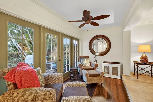 a living room with furniture a clock and a large window