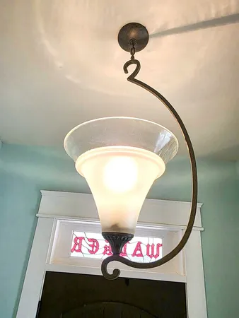 a view of an empty room with a fireplace and a window