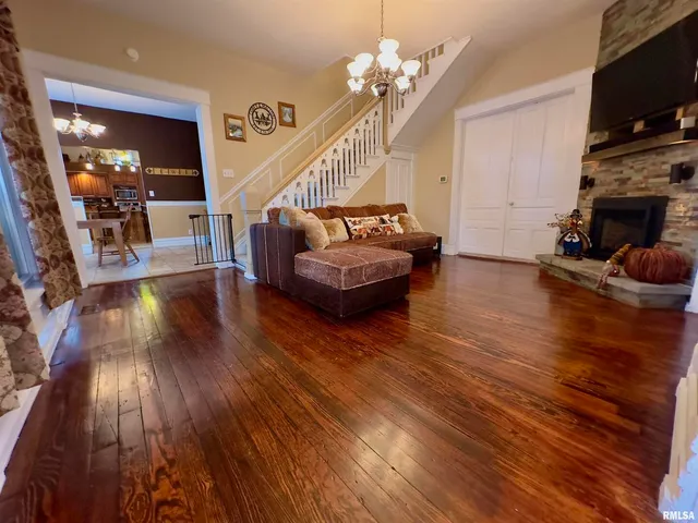 a view of a room with a chandelier fan and a potted plant