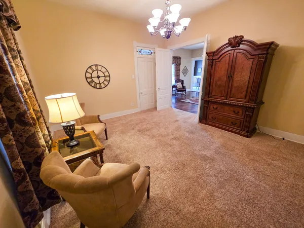 a spacious bedroom with a bed and a flat screen tv