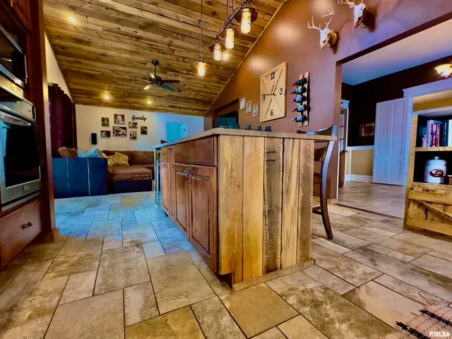 a bedroom with a bed dresser and flat screen tv
