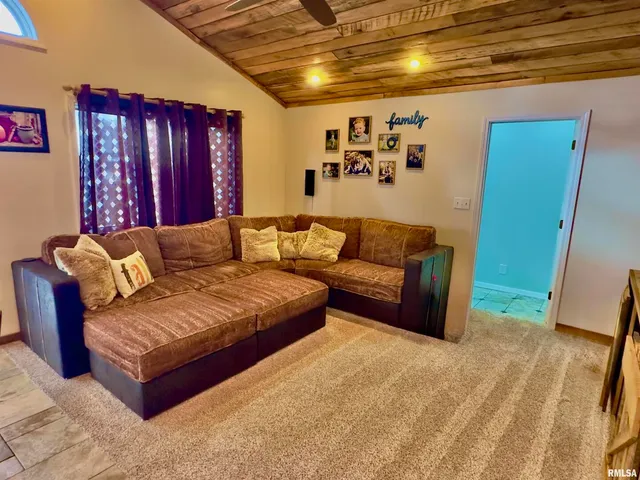 a view of a livingroom with wooden floor and stairs