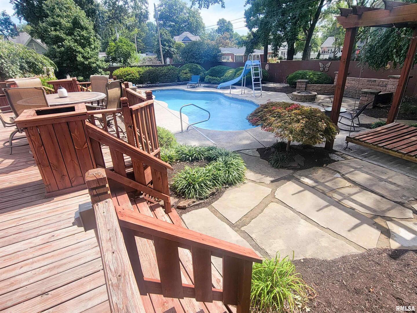 521 North Locust Street Flora, IL 62839 - Photo 4 of 100 a view of a patio with table and chairs with wooden floor and fence