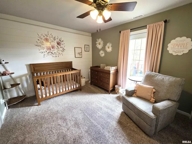 a view of a patio with a table chairs and a barbeque