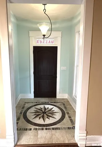a view of a living room and entryway with wooden floor