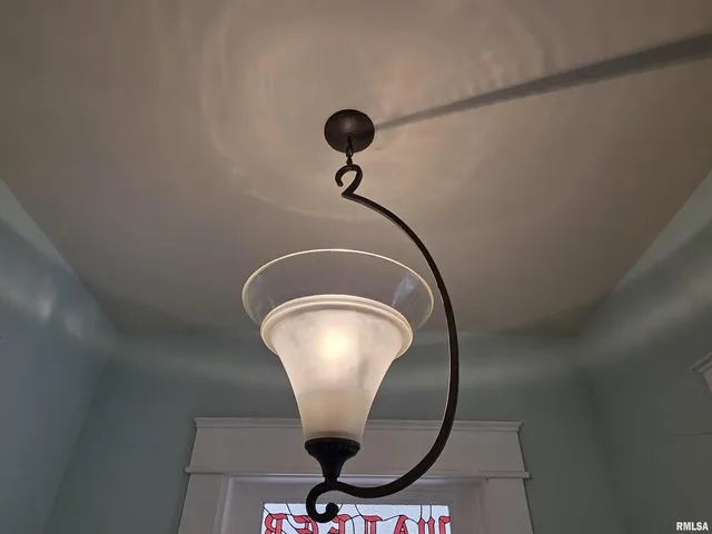 a living room with furniture a fireplace and a chandelier