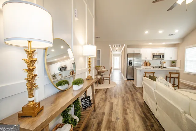 a very nice looking open dining room with kitchen island