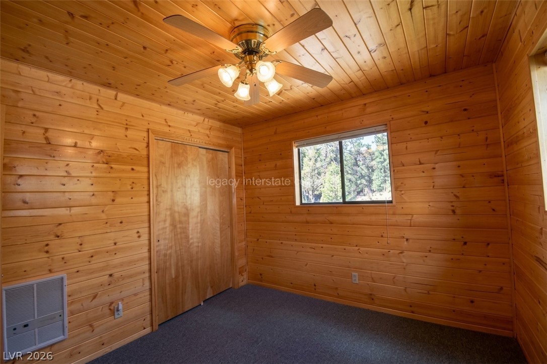 1129 East Ponderosa Road Hatch, UT 84735 - Photo 27 of 47 Rich wood paneling covers the walls and ceiling of this cozy cabin bedroom.