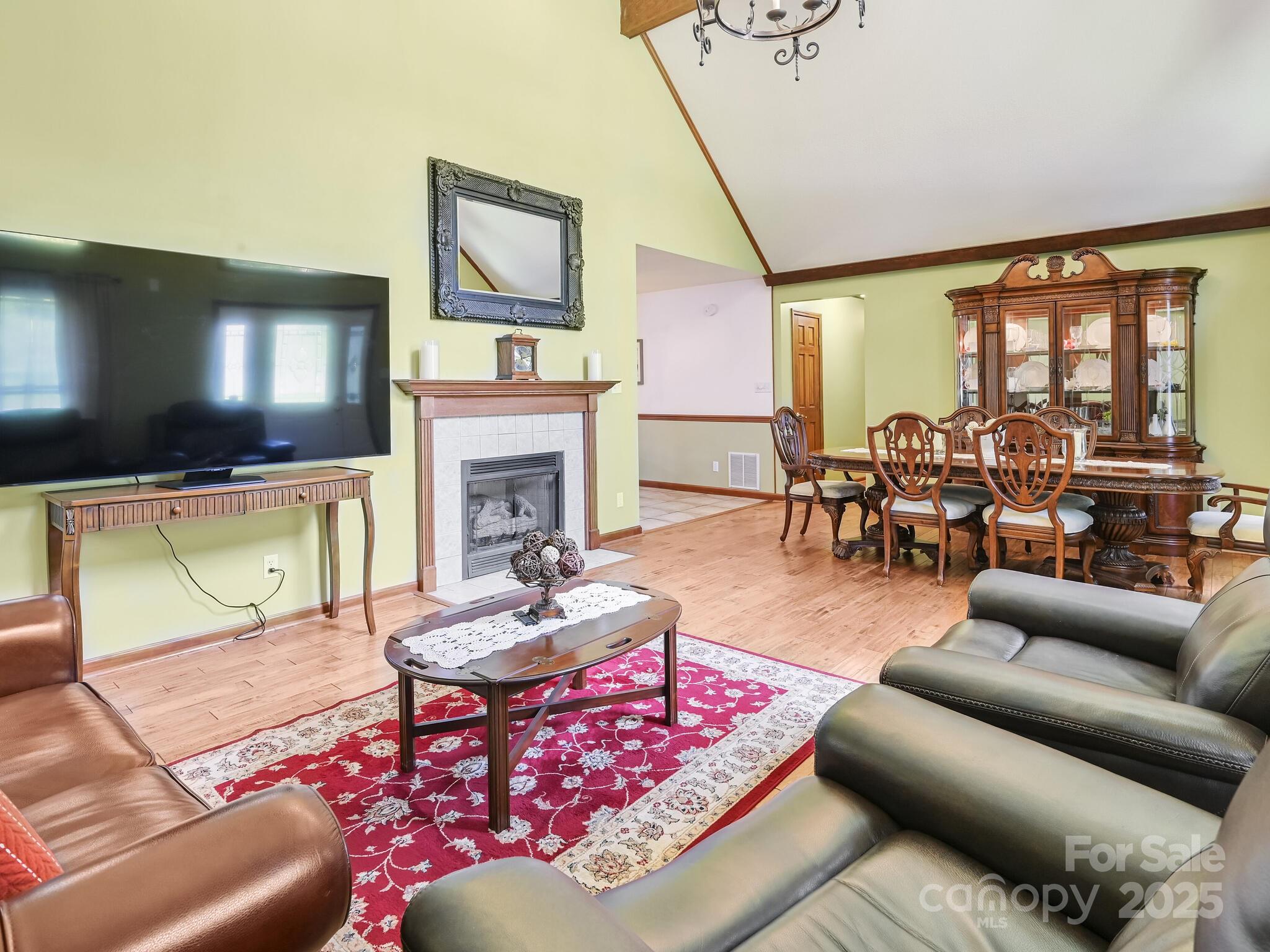20 Brooks Cove Road Candler, NC 28715 - Photo 14 of 43 a living room with furniture a flat screen tv and a floor to ceiling window