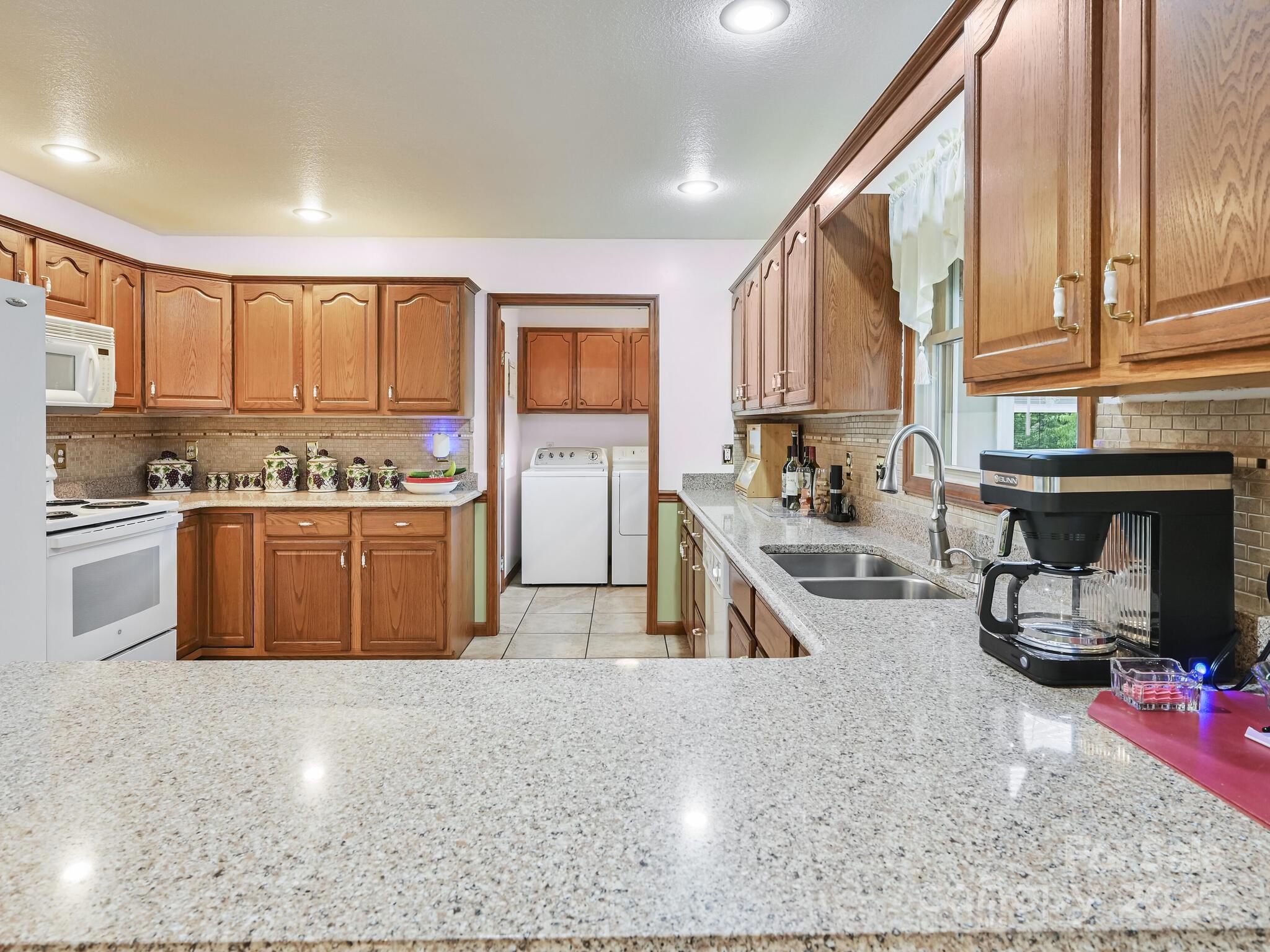 20 Brooks Cove Road Candler, NC 28715 - Photo 17 of 43 a kitchen with stainless steel appliances granite countertop a stove a sink and a refrigerator
