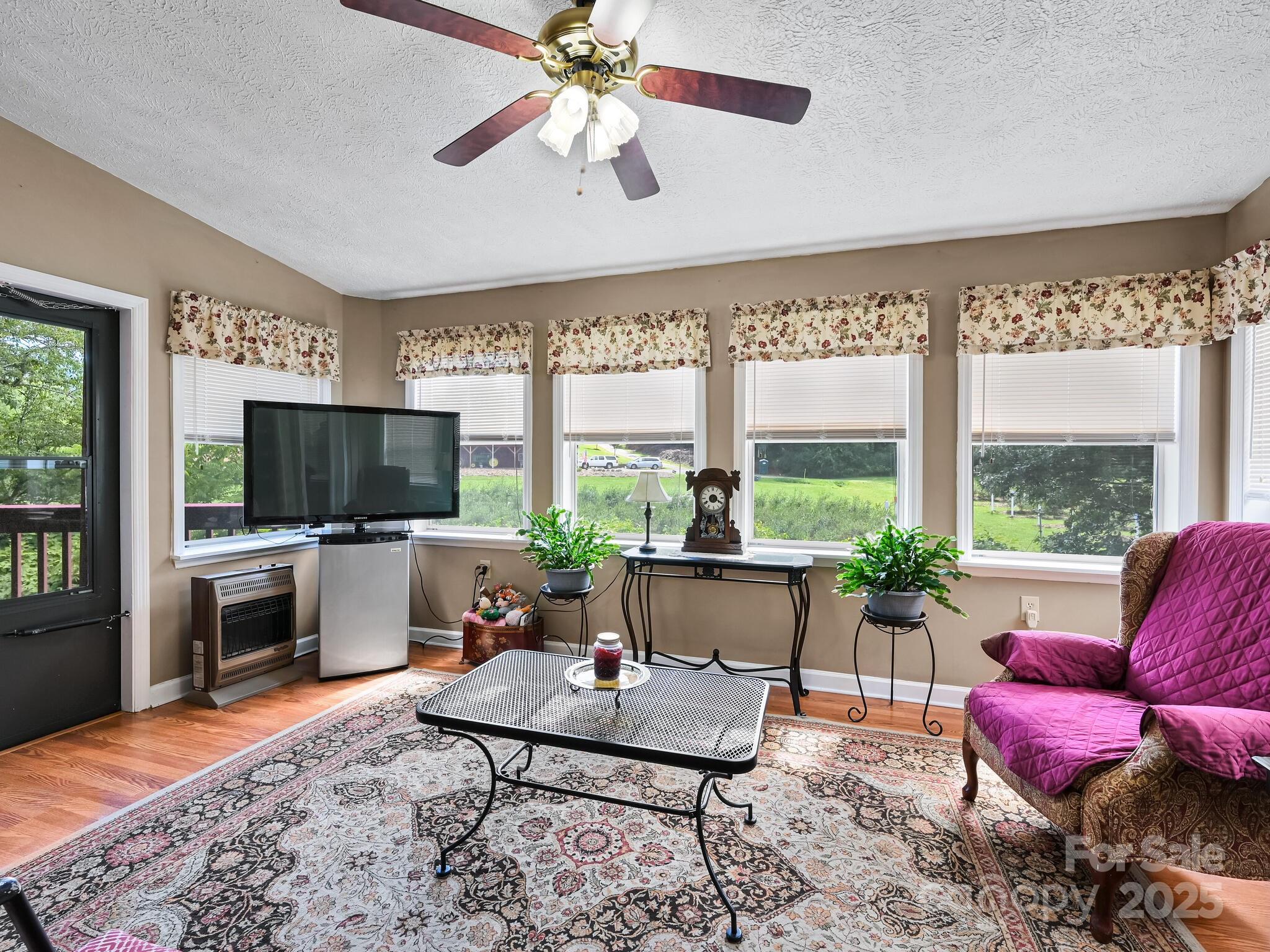 20 Brooks Cove Road Candler, NC 28715 - Photo 24 of 43 a living room with furniture a flat screen tv and a large window