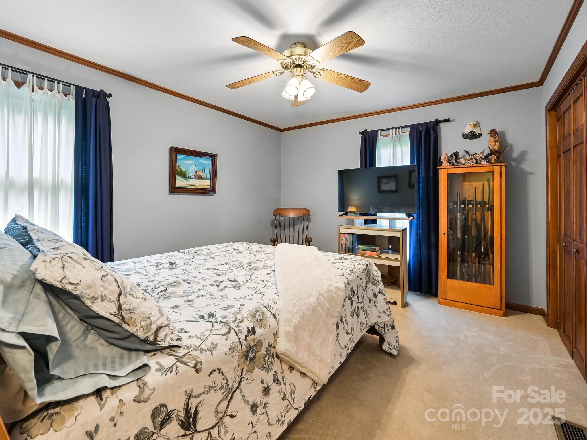 20 Brooks Cove Road Candler, NC 28715 - Photo 29 of 43 a bedroom with a bed and a chandelier