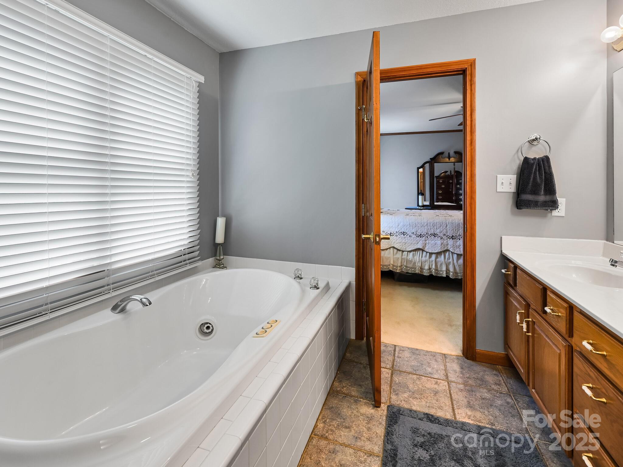 20 Brooks Cove Road Candler, NC 28715 - Photo 33 of 43 a en suite spacious bathroom with a tub sink and view bedroom