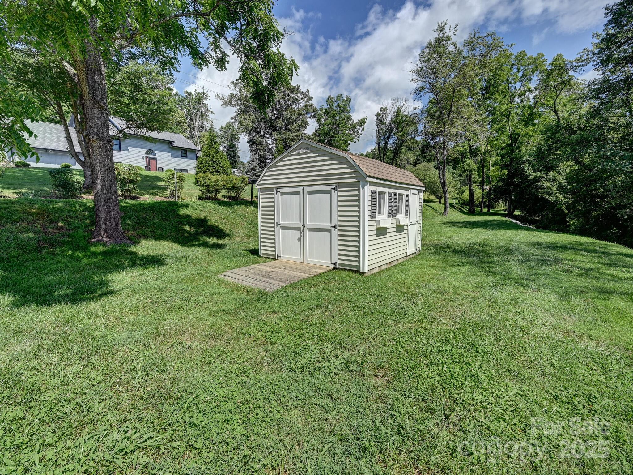 20 Brooks Cove Road Candler, NC 28715 - Photo 39 of 43 a house with green field in front of it