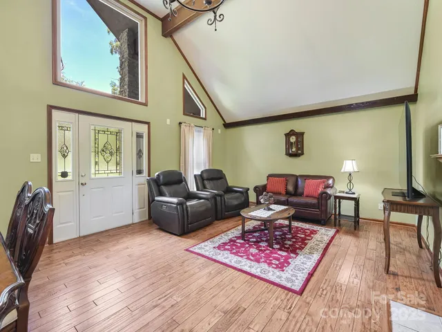 a living room with furniture rug and wooden floor