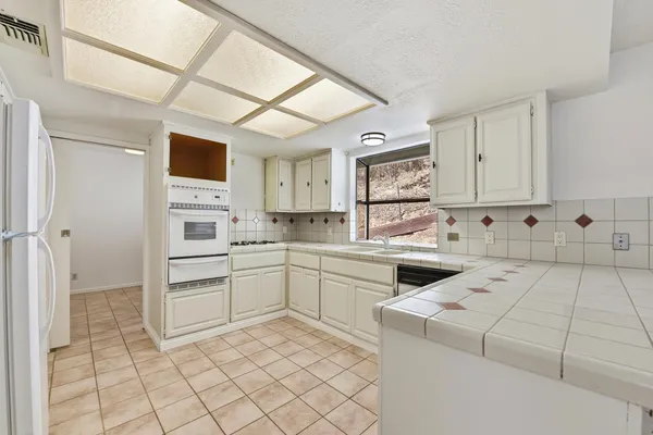 a kitchen with cabinets appliances and a counter top space