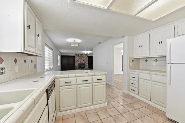 a kitchen with white cabinets appliances and sink