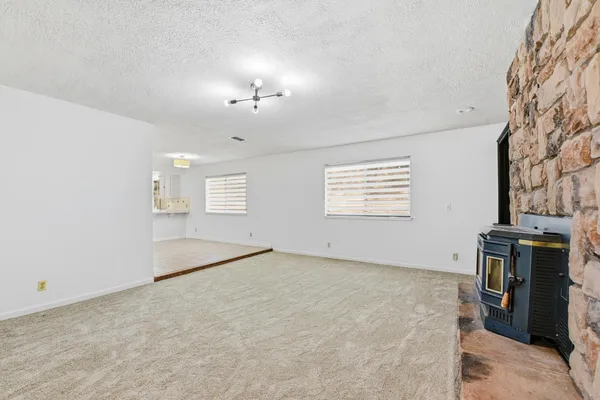 a view of a kitchen with a stove wooden floor and a window