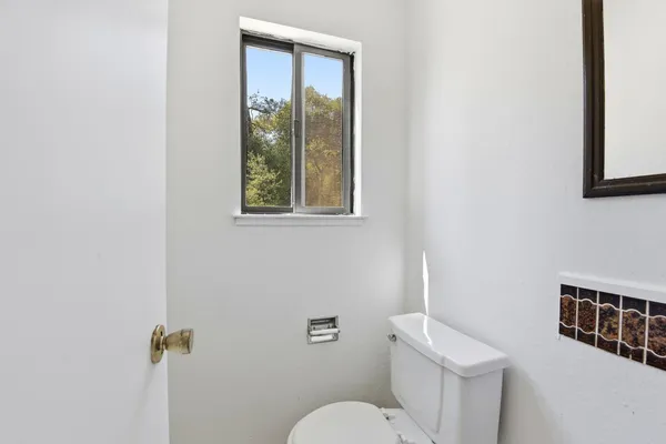 a white toilet sitting next to a bathroom sink