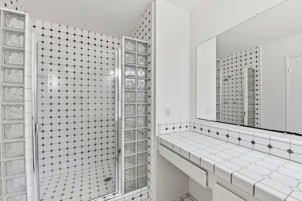 a bathroom with a shower and a sink